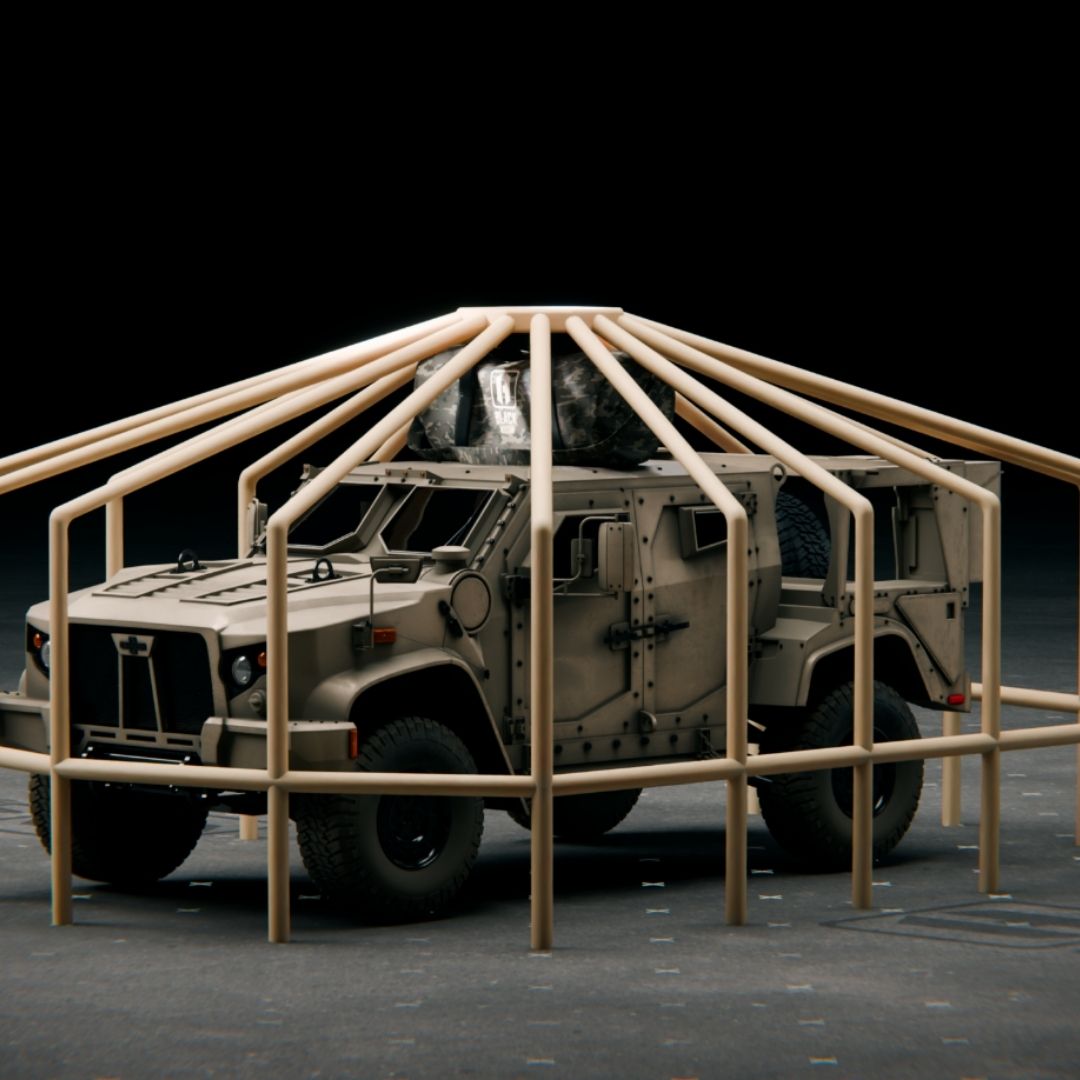 Aerial view of the light tactical vehicle completely obscured and blended into the multi-spectrum camouflage hide of the fully deployed Black Widow system. The hide breaks up the outline with irregular shapes, achieving full signature reduction.